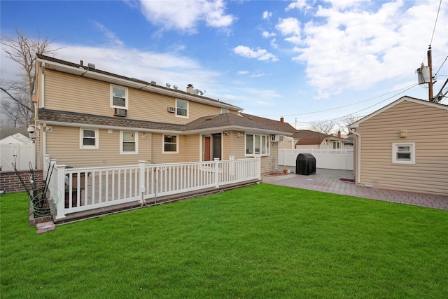 back of house featuring a patio area and a lawn