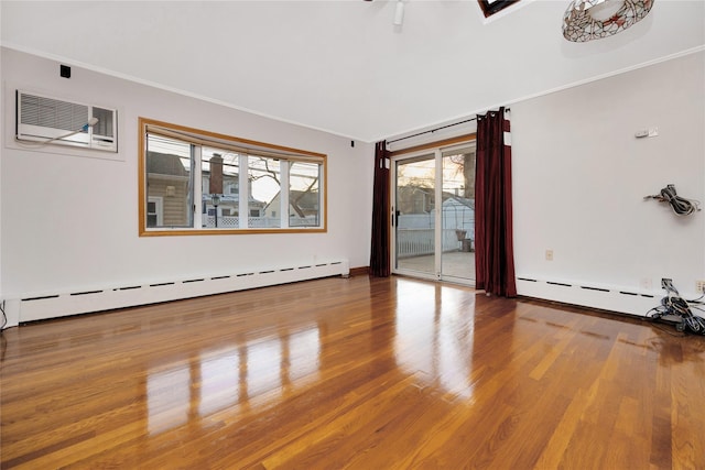 unfurnished room featuring baseboard heating, crown molding, and wood-type flooring