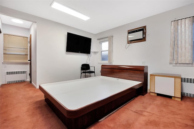 carpeted bedroom featuring radiator and a wall mounted air conditioner