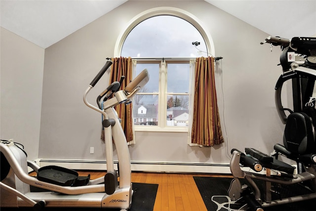 workout area featuring vaulted ceiling and hardwood / wood-style flooring