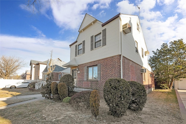 view of property exterior with a wall unit AC