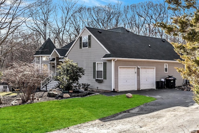 view of side of home featuring a lawn and a garage