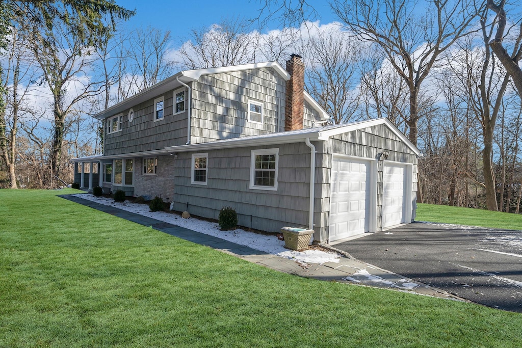 view of side of property with a lawn