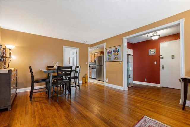 dining room with dark hardwood / wood-style flooring