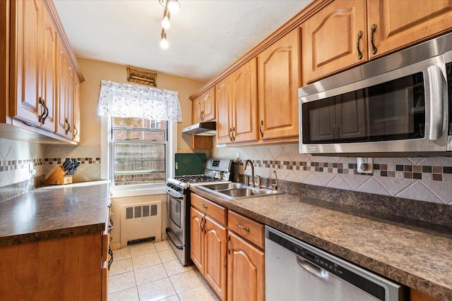 kitchen with stainless steel appliances, radiator, tasteful backsplash, and sink