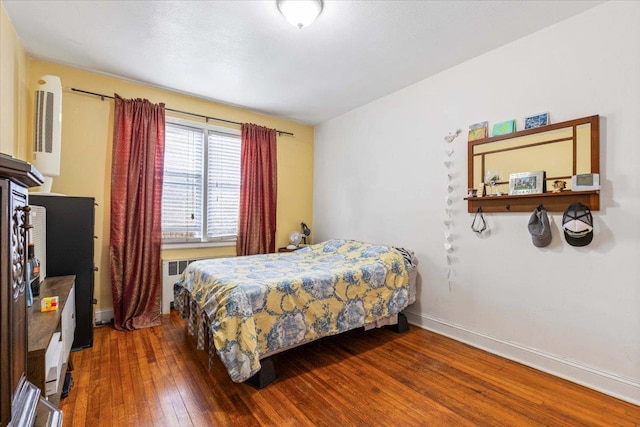 bedroom with dark hardwood / wood-style floors