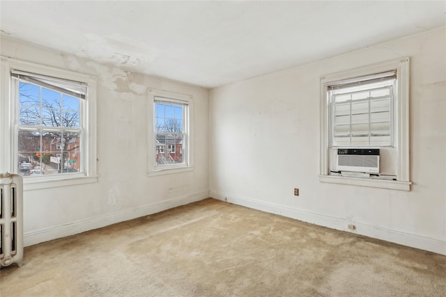 carpeted spare room featuring cooling unit and radiator heating unit