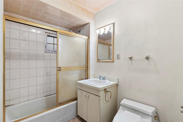 full bathroom with toilet, vanity, and bath / shower combo with glass door