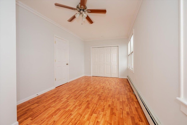 interior space with a baseboard radiator, light hardwood / wood-style floors, a closet, ornamental molding, and ceiling fan