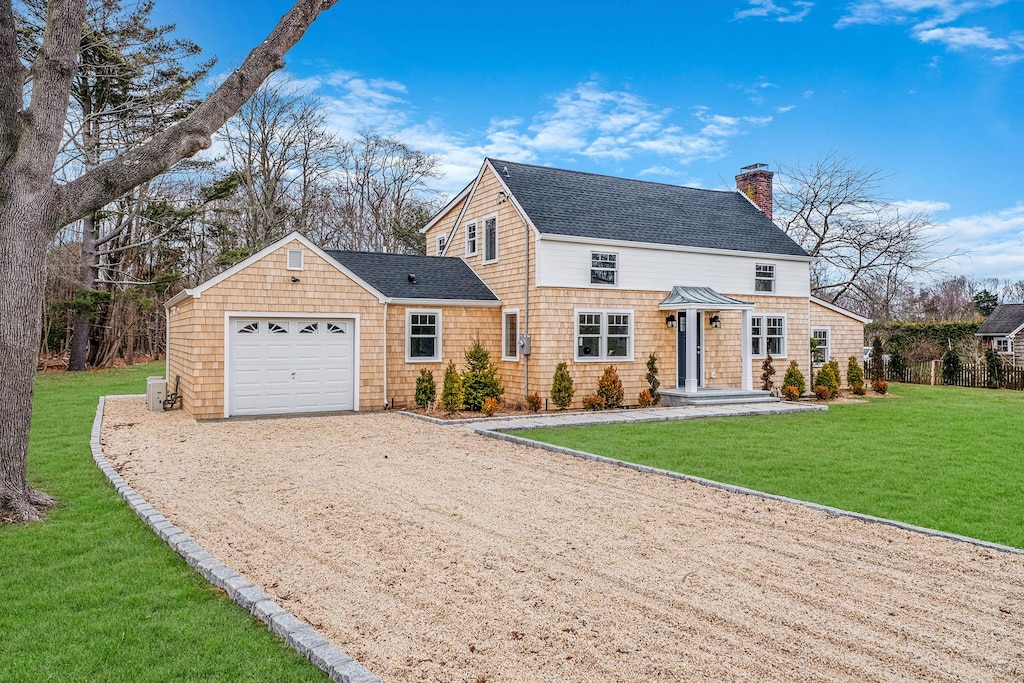 view of front of house with a front yard and a garage