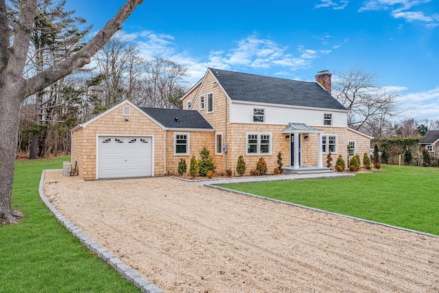 view of front of house with a front yard and a garage