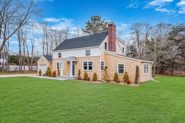 view of front of property with a front yard and a garage