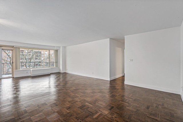 empty room with dark parquet flooring