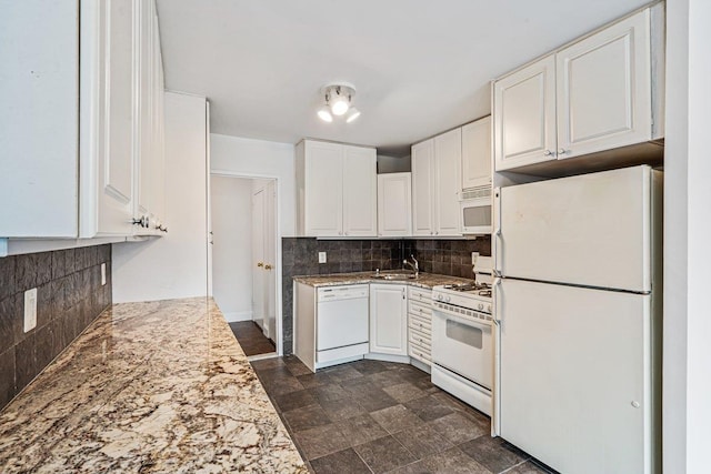 kitchen featuring white appliances, white cabinets, and tasteful backsplash