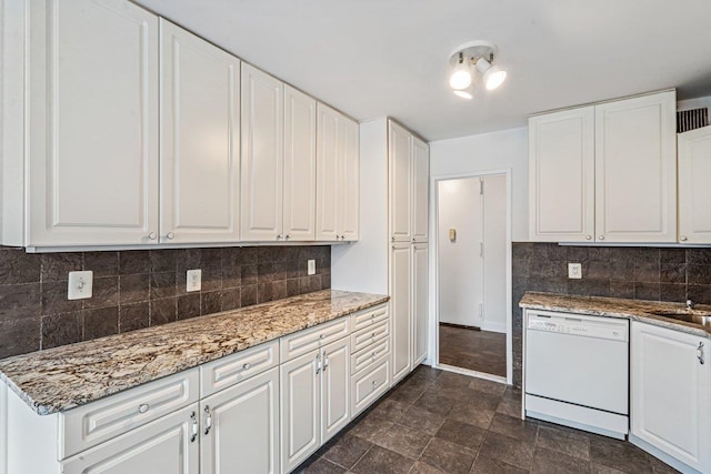 kitchen with decorative backsplash, white cabinetry, dishwasher, and light stone counters