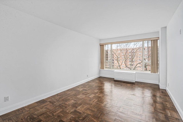 empty room with dark parquet flooring