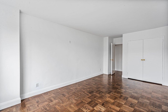 unfurnished bedroom featuring dark parquet floors