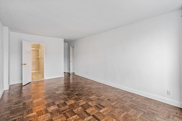 empty room featuring dark parquet flooring