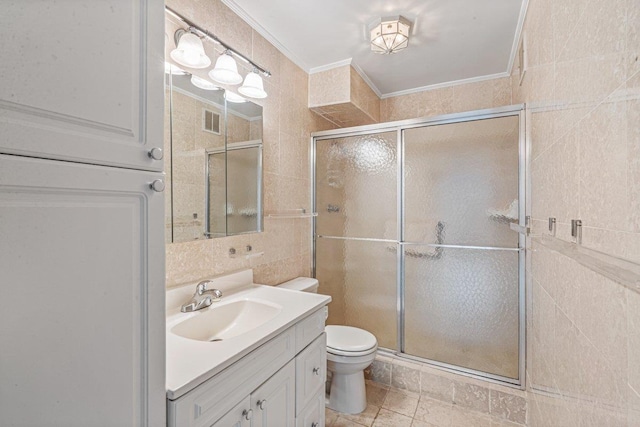 bathroom featuring a shower with door, vanity, tile walls, and ornamental molding