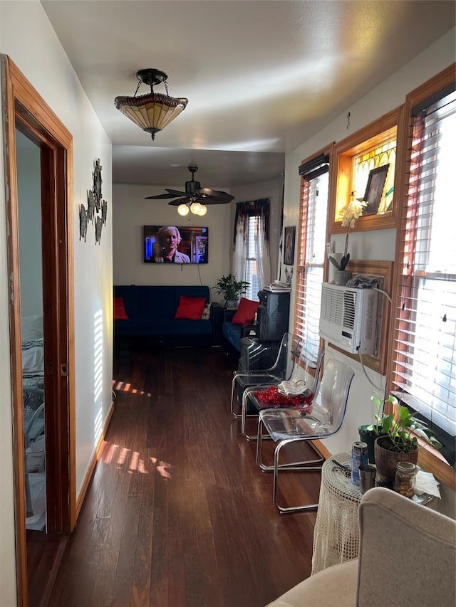 living room with ceiling fan and dark hardwood / wood-style flooring