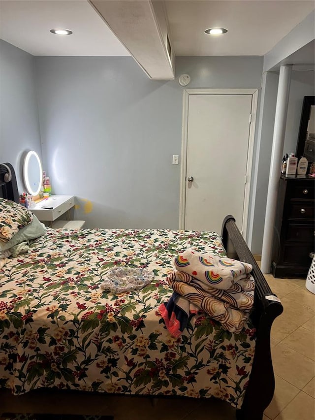 bedroom with light tile patterned floors