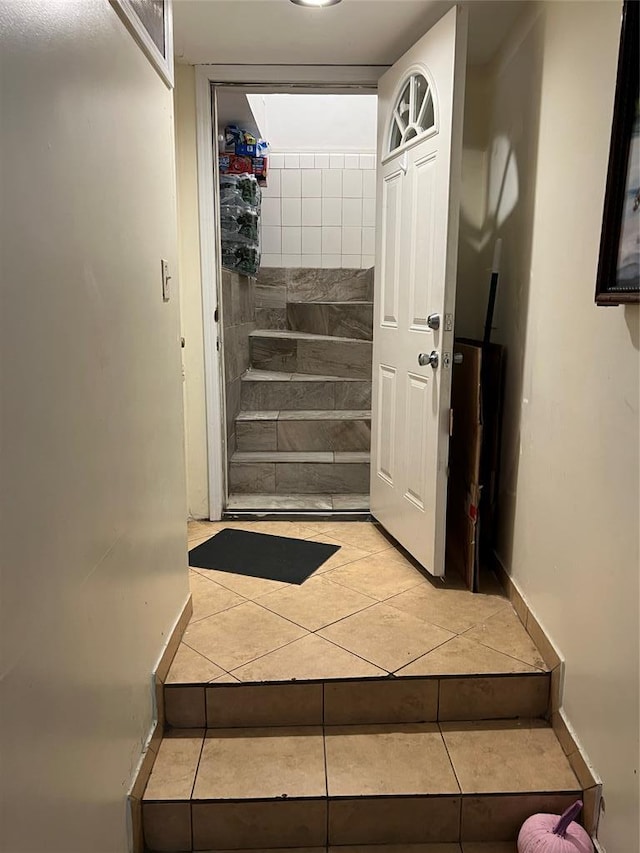 stairway featuring tile patterned flooring