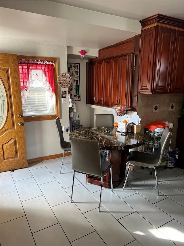 dining space featuring light tile patterned floors