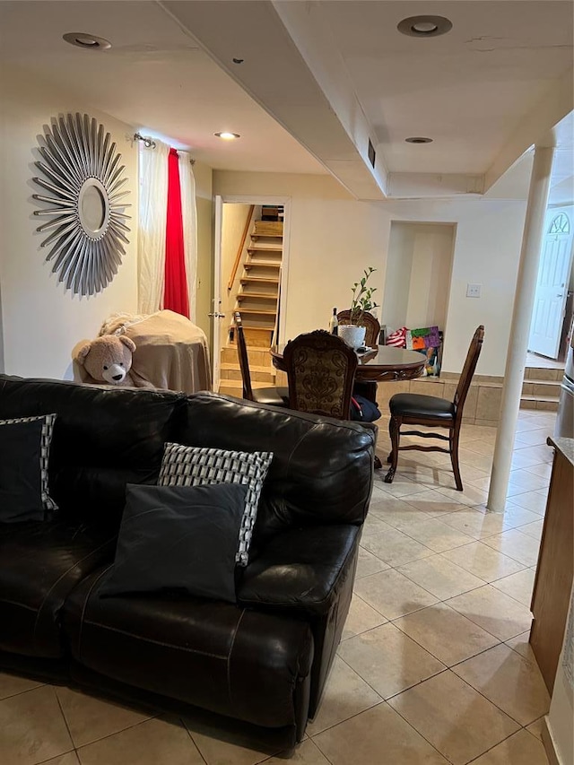 tiled living room featuring a raised ceiling