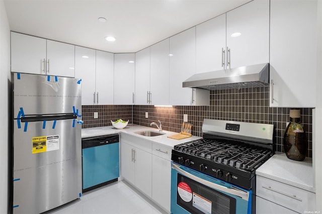 kitchen featuring sink, stainless steel appliances, backsplash, and white cabinetry