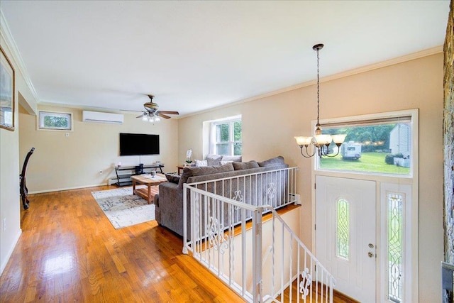 400 Philo St, New Windsor, NY 12553 - living area with a wall mounted air conditioner, crown molding, a chandelier, wood finished floors, and ceiling fan