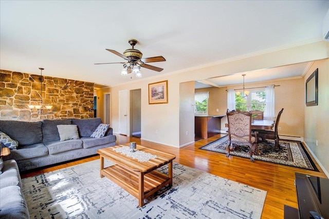 400 Philo St, New Windsor, NY 12553 - living area with a chandelier, wood finished floors, ornamental molding, baseboards, and a ceiling fan