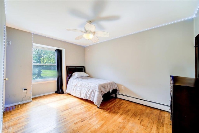 400 Philo St, New Windsor, NY 12553 - bedroom featuring baseboard heating, light wood-style floors, a ceiling fan, and baseboards