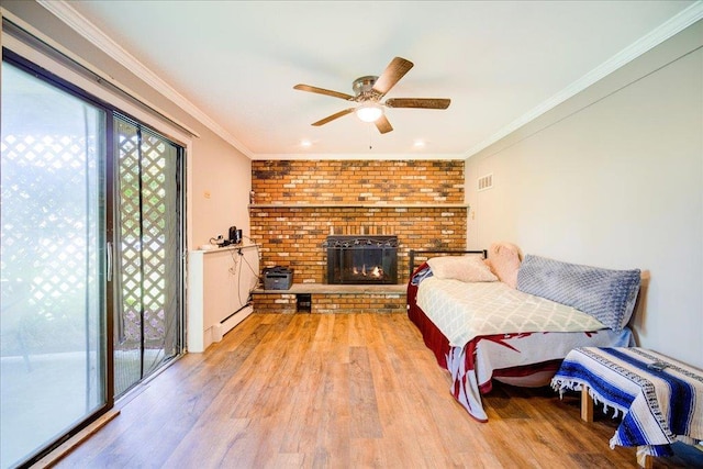 400 Philo St, New Windsor, NY 12553 - living area featuring healthy amount of natural light, light wood-type flooring, ceiling fan, a brick fireplace, and ornamental molding