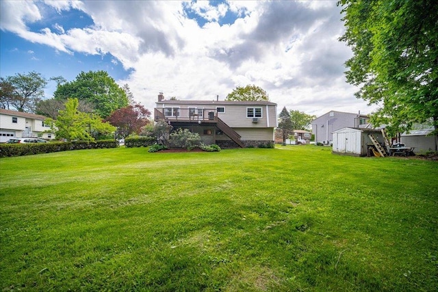 400 Philo St, New Windsor, NY 12553 - view of grassy yard with stairway, a storage unit, an outbuilding, and a deck