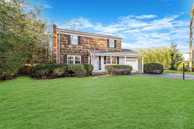 view of front of house featuring a front yard and a garage