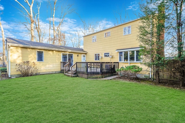 back of house featuring a yard and a wooden deck