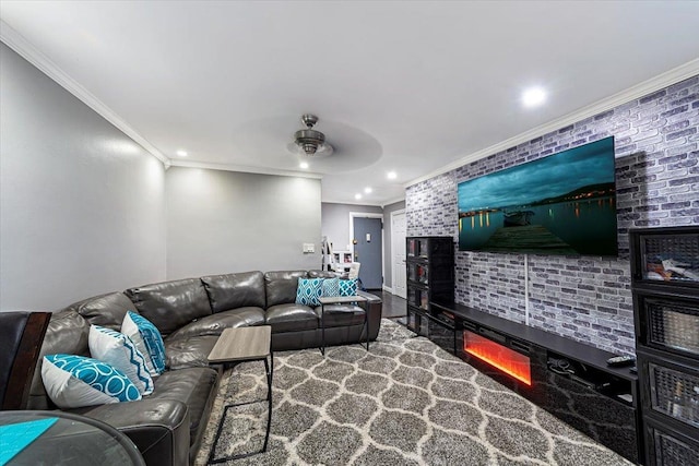 living room featuring ceiling fan, ornamental molding, and brick wall