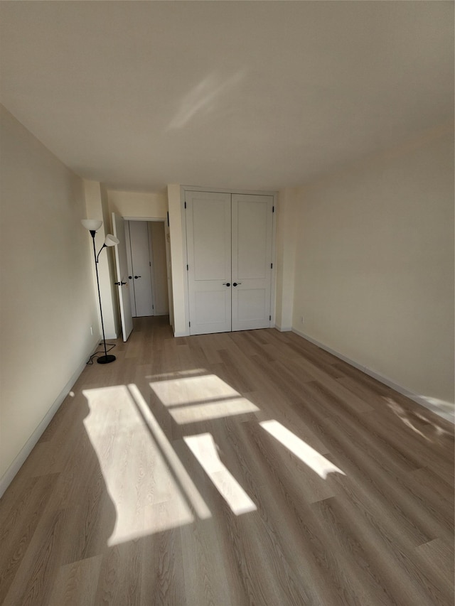 unfurnished bedroom with light hardwood / wood-style floors