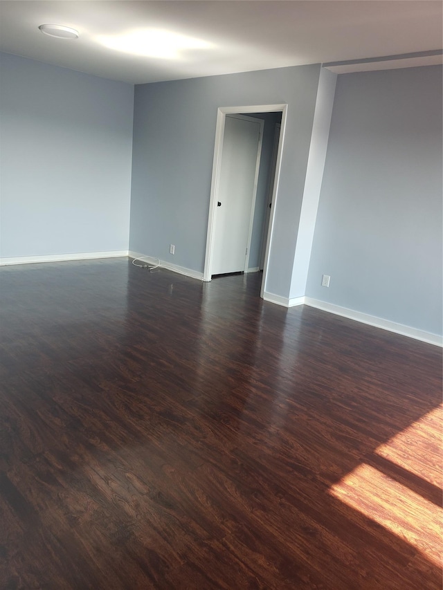 empty room with dark hardwood / wood-style floors