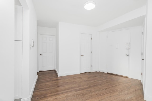 empty room with dark hardwood / wood-style floors