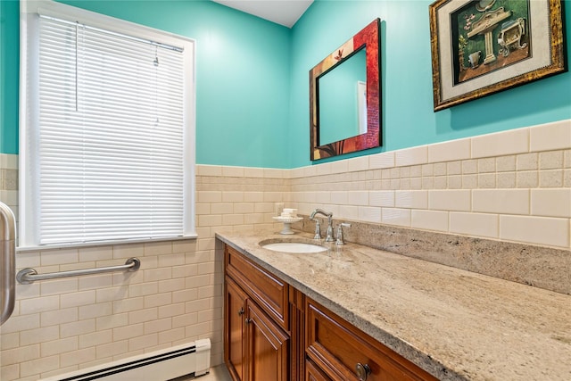 bathroom featuring tile walls, a baseboard radiator, and vanity