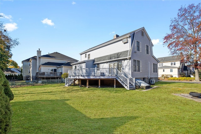 rear view of house featuring a yard and a wooden deck