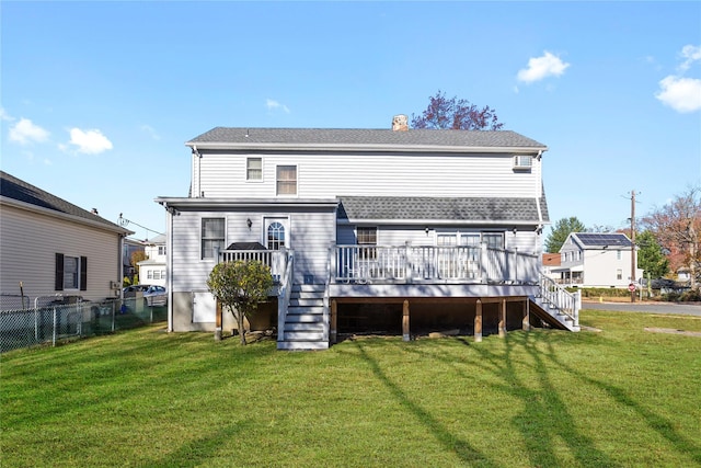 back of house featuring a yard and a wooden deck