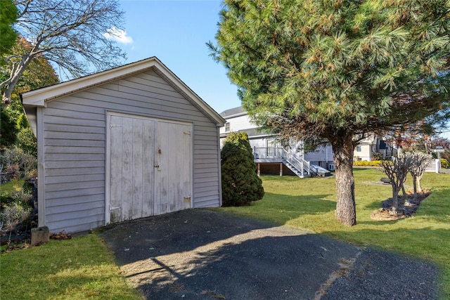 view of outbuilding featuring a yard