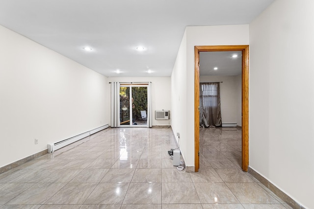 empty room featuring a baseboard heating unit and a wall unit AC