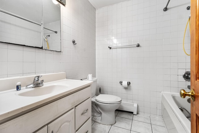 full bathroom featuring tile patterned floors, vanity, tile walls, and baseboard heating