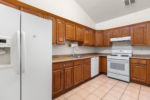 kitchen featuring sink, white appliances, light tile patterned flooring, and vaulted ceiling