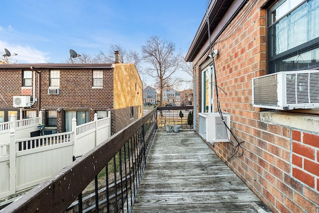 wooden terrace featuring cooling unit