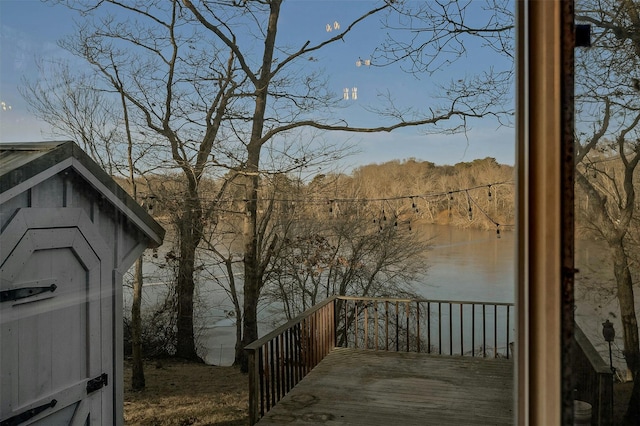 wooden terrace featuring a water view