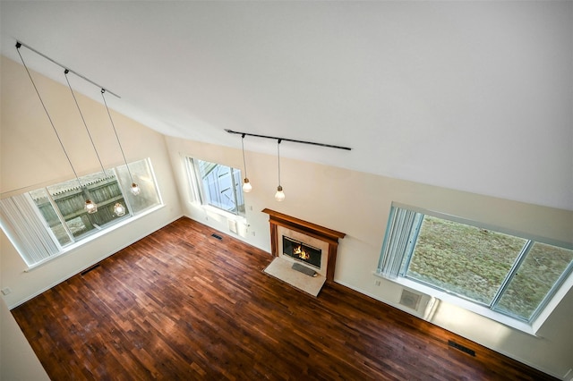 unfurnished living room with dark hardwood / wood-style flooring and a wealth of natural light